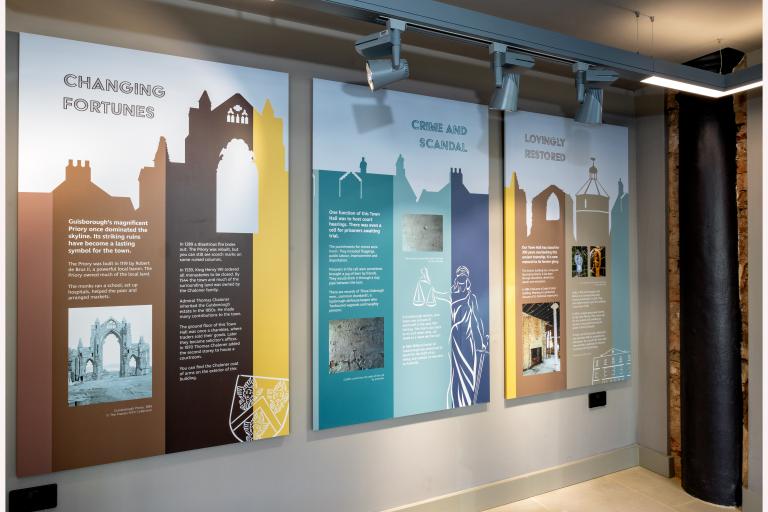 Posters explaining the history of Guisborough attached to the wall