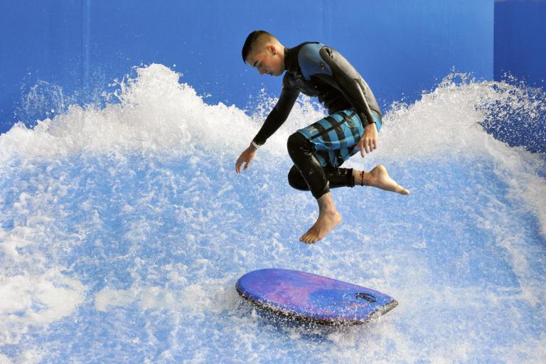 Man doing inside surfing at Flowrider