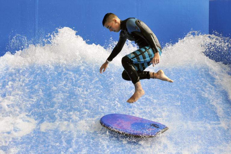 Man doing inside surfing at Flowrider.