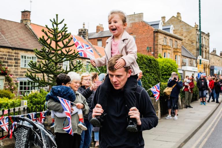 A young girl and her father watching the parade in Loftus.