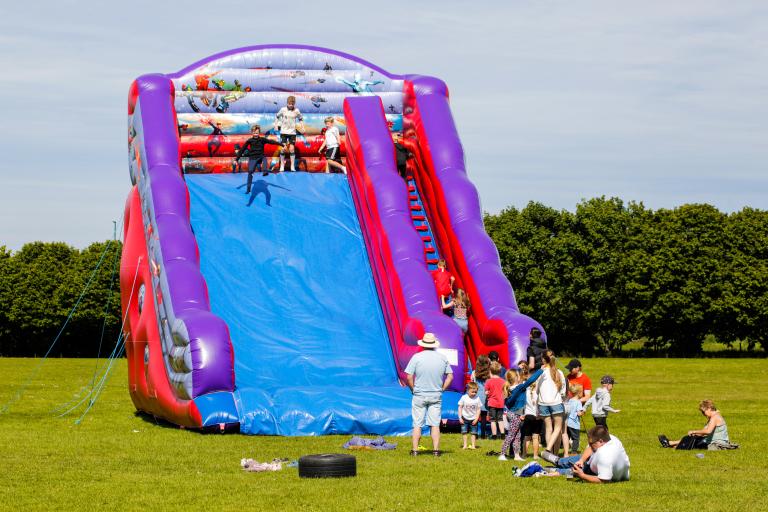 Children having fun on the bouncy castle at the Jubilee Fete