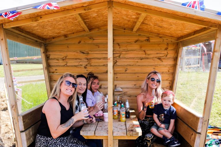 Family enjoying their time and having a meal at the Jubilee Fete.