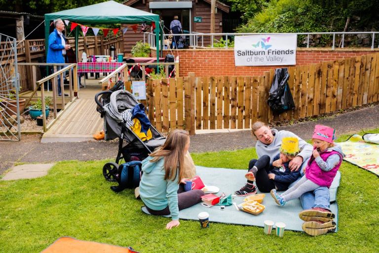 Family having a picnic at the Saltburn Valley Gardens.