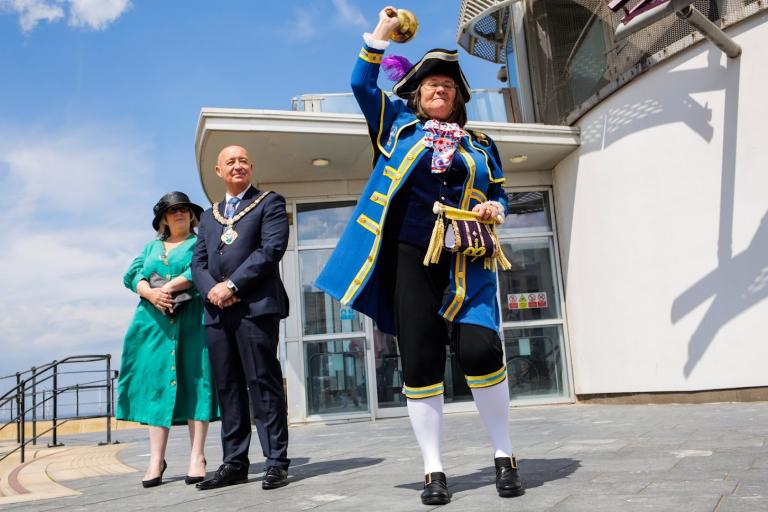 The Town Crier giving his Declaration next to the Redcar Beacon. Next to him there is the Mayor, Stuart Smith, and his wife.