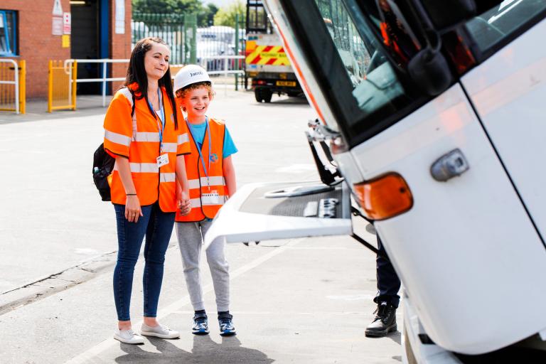 Jacob and his mother in front of a bin wagon in the parking lot of the Redcar and Cleveland Central Depot