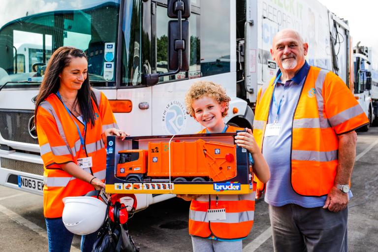 Jacob and his mother holding a bin wagon toy offered by Cllr Barry Hunt on behalf of the council