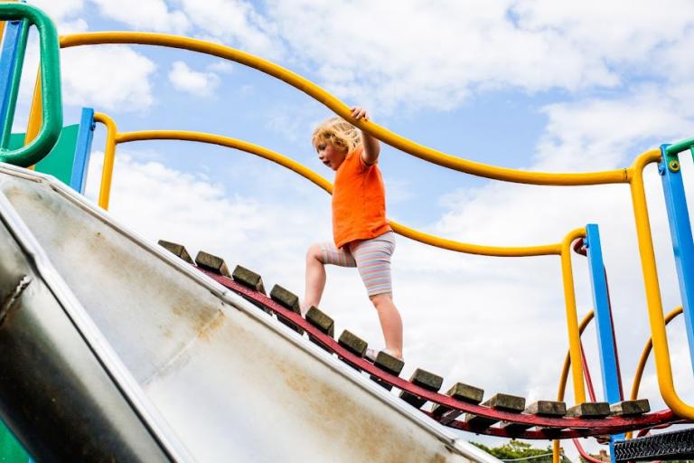 Image of a child on the playing ground in Zetland Park.