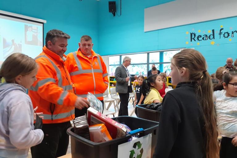 Gordon Myers and recycling officers, guiding South Bank Primary pupils to sort out the waste items as part of the recycling game.