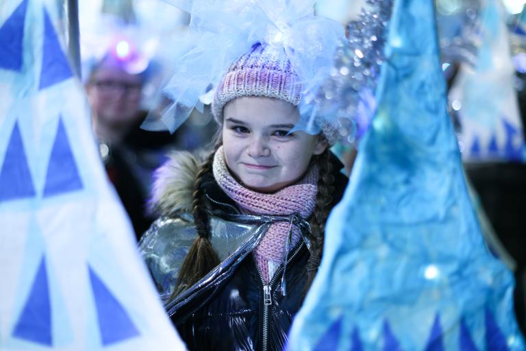 Girl surrounded by blue and silver Christmas decorations
