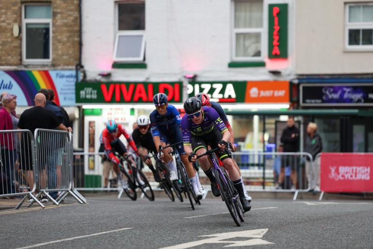 Cyclists speeding through the streets at the Men Circuit Race