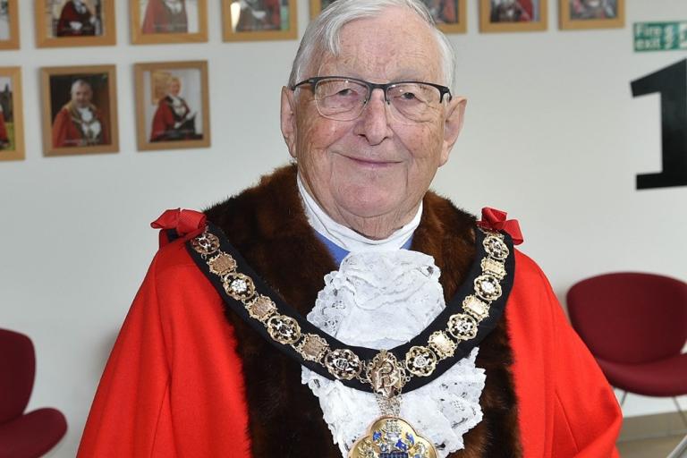 Image of Cllr Malcolm head wearing his red mayoral robes and wearing a gold ceremonial chain.