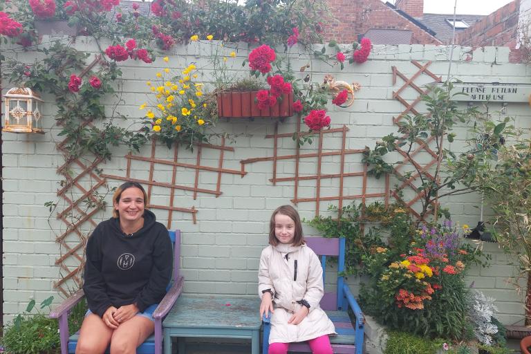 Samantha Jackson, from Muriel Street, with her daughter Frances in their colourful alleyway.