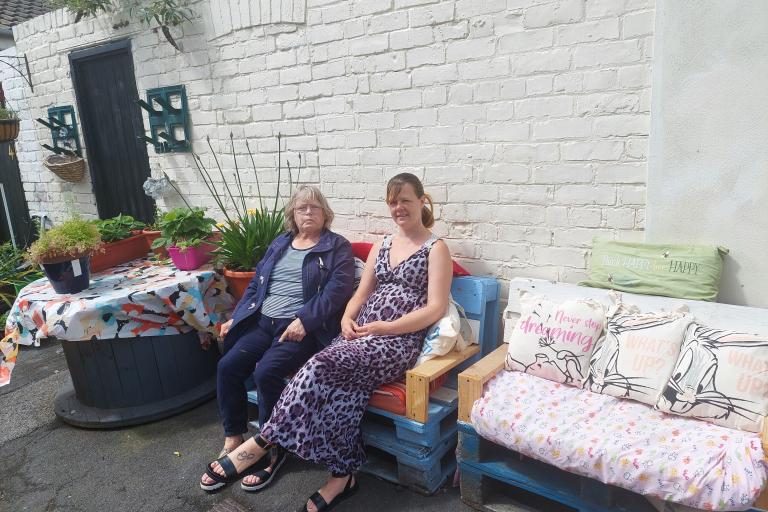 Pearl Johnson(left hand side) and Samantha Douglas (right hand side), residents of Charles and Frances Street seating on the pallet benches created by Samantha’s husband