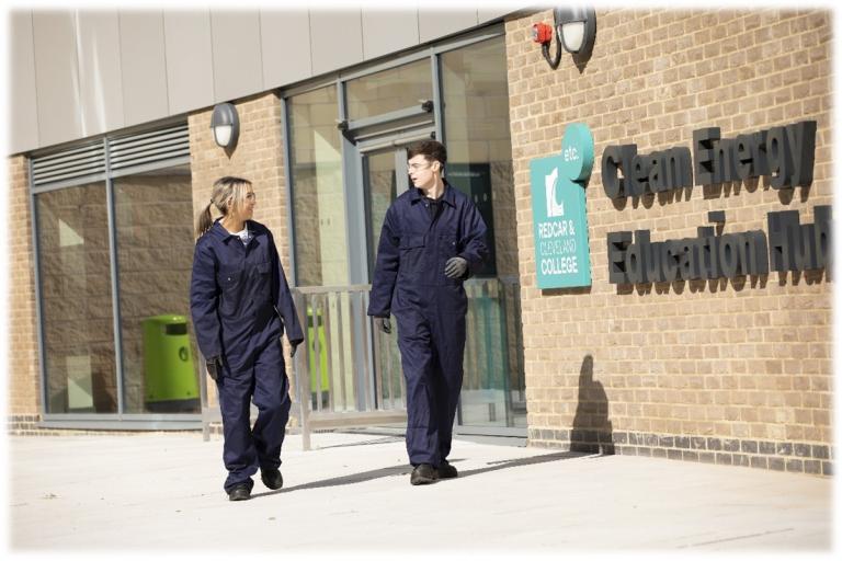 Image of two students wearing blue overalls outside of the clean energy hub in Redcar College