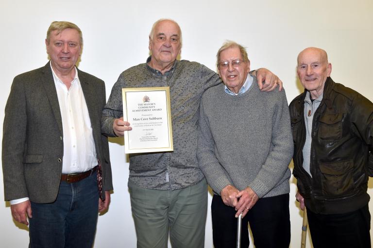 Members of Man Cave with their award