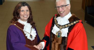 Image of Cllrs Ian Hart (right) and Ceri Cawley left at the Mayor's investiture. Ian is wearing red mayoral robes and Ceri is wearing purple deputy mayoral robes.