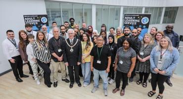 Image of the adult learning team stood together. The mayor or redcar and cleveland can be seen in the centre of the image wearing his ceremonial chains.