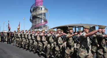 Image shows armed forces veterans parading.