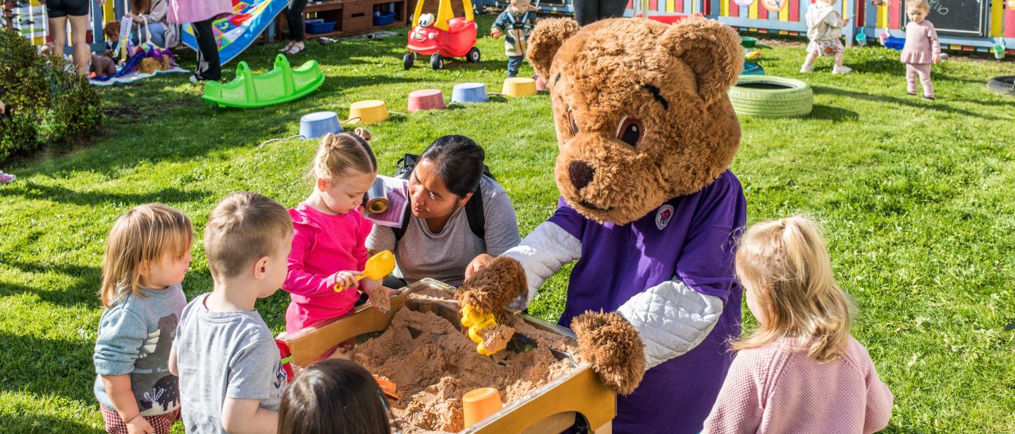 Children playing with the Family Hubs mascot at Dormanstown Family Hub