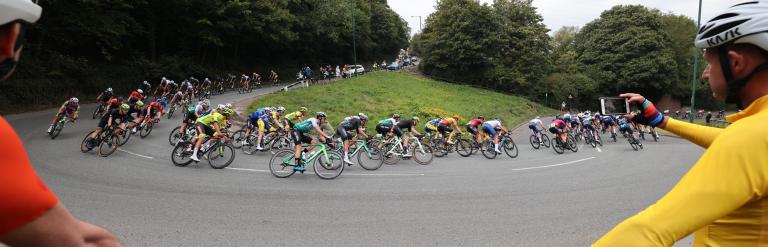Two cyclists watching the competition of the Tour Series 2022