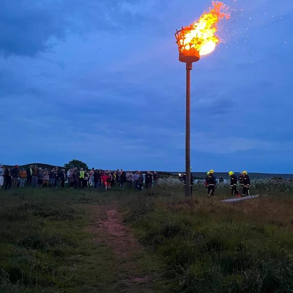 The Birk Brow Beacon lit for the Platinum Jubilee celebration during the night.