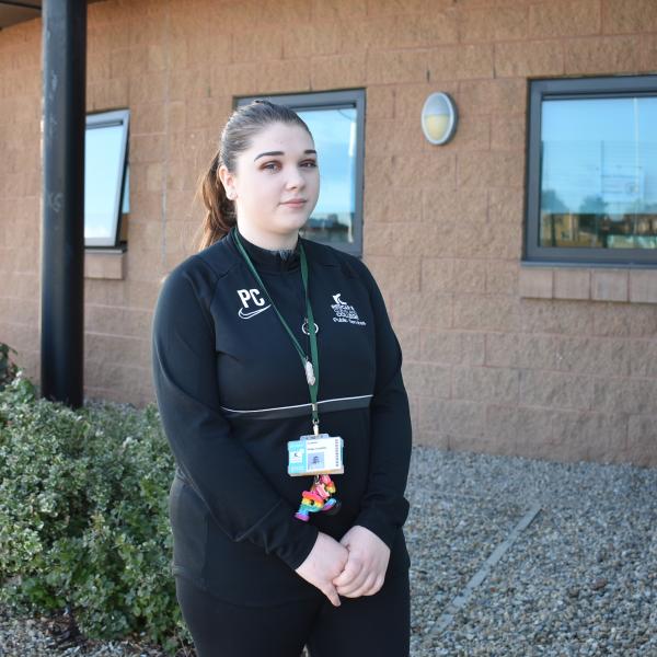 Image of a young woman dressed in black clothes.