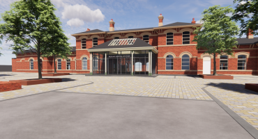 CGI image showing a renovated red brick train station with trees in the foreground.